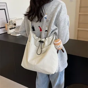 Casual large capacity canvas shoulder bag for women, stylish daily commuter crossbody bag.