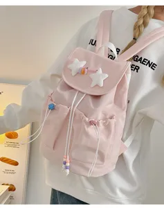 Cute pink casual backpack for girls with soft plush stars and front pockets, ideal daily bag.