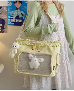 Ballet style ruffled ita bag with clear mesh window and cute plush pendants for daily wear.