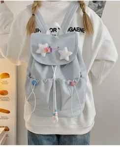 Detailed view of cute Japanese casual backpack with fluffy star decor and handy front pockets.