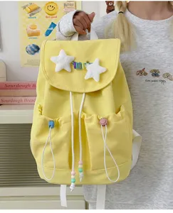 Cute Japanese style yellow school backpack for girls, featuring plush stars and cute charms.