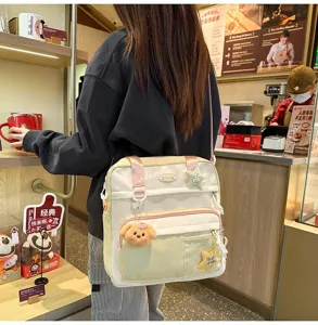 Sac à dos bandoulière en toile décontracté pour étudiants avec joli pendentif en peluche.