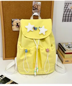Cute yellow canvas backpack with plush stars, casual school bag details and front pockets.