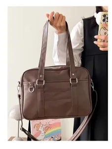 Close-up of the brown Japanese JK uniform shoulder bag, showing PU leather texture and straps.