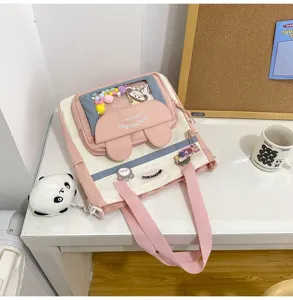 Bonito bolso bandolera de lona rosa y blanca para estudiantes con bolsillo transparente