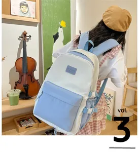 Charming light blue and white student backpack worn in a cozy artistic room setting.
