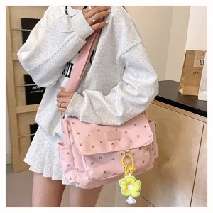 Pink floral messenger bag details, large capacity student crossbody bag with cute flower pendant.