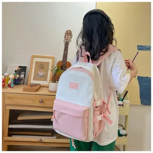 Detail view of the cute pink and white dual-tone student backpack lifestyle scene.