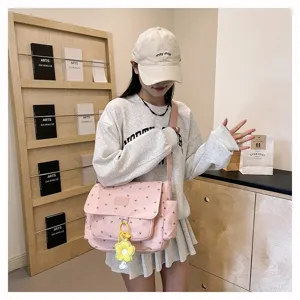 Pink floral canvas messenger bag for women, large capacity casual crossbody school bag.