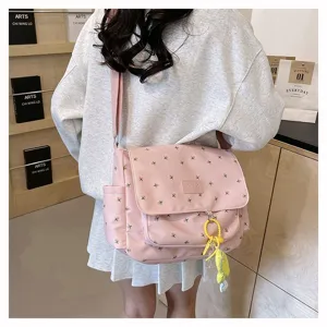 Detailed view of pink floral canvas messenger bag, large capacity Japanese style school bag.