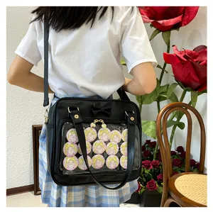 Black PU leather itabag featuring clear front display pocket, cute bow and adjustable shoulder strap.