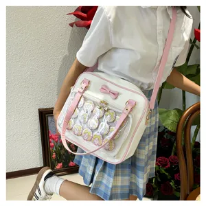 Cute pink and white ita bag with transparent window and anime badges, perfect for JK uniform style.