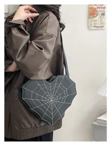 Detail shot of the Gothic heart spiderweb crossbody bag, featuring contrast white stitching.