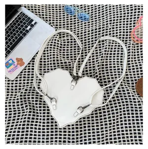 White heart bat shaped multi-functional convertible backpack and crossbody bag for women.