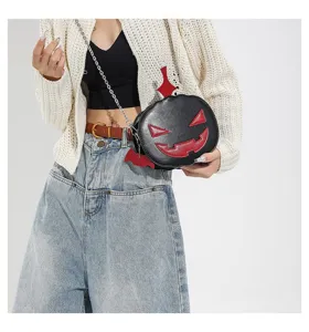 Detail view of Halloween quirky pumpkin crossbody bag featuring contrast red bat wings and cute design.