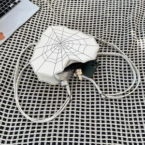 Detailed view of the white PU leather heart spider web cross-body bag texture and interior.