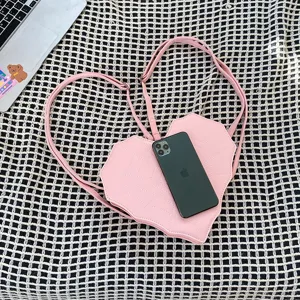 Pink heart-shaped gothic crossbody backpack featuring spider web quilted design for women.