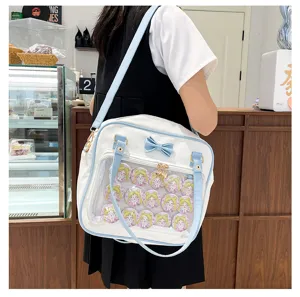 Cute white and blue ita bag with clear pocket and anime badges, perfect for daily fashion.