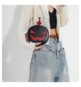 Detailed view of a creative Halloween pumpkin crossbody bag featuring chic color blocking.