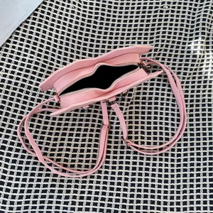 Pink heart bat shaped multi-functional backpack and cross-body bag detail view, punk.