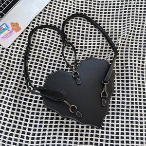Gothic heart-shaped multiway backpack and crossbody bag with cool contrast stitching.