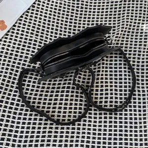 Black punk style multi-functional crossbody backpack with unique bat shape and white stitching.