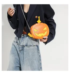 Halloween pumpkin shape crossbody bag detail view, orange leather with cute funny face design.
