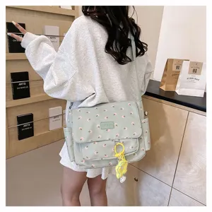 Japanese style floral canvas messenger bag with large capacity and cute pendant for students.