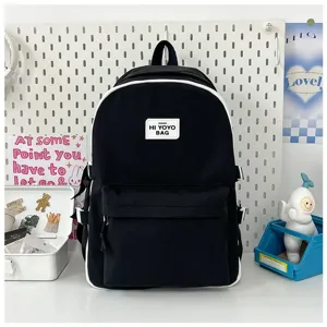 Japanese style black canvas school backpack with white piping and front logo patch for students.