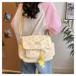 Canvas floral messenger bag with cute flower pendant, casual daily crossbody bag for students.