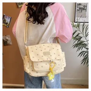 Cute floral canvas crossbody messenger bag for women, casual Japanese style daily shoulder bag.