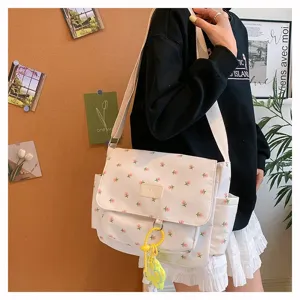 Japanese style canvas messenger bag for students, large capacity floral crossbody bag with pockets.