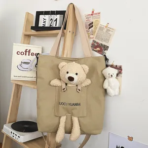 Bolso bandolera de lona con oso de peluche y colgante bonito para mujeres de uso diario.