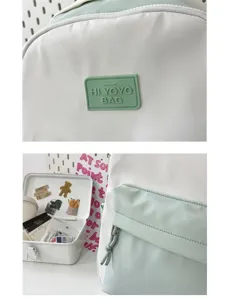 Close-up detail of the Japanese style backpack showing the front logo badge and pocket.