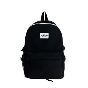 Black casual school backpack with white contrast piping and front pocket for daily student use.