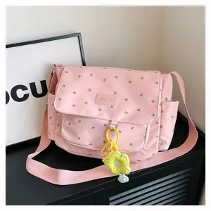 Pink floral messenger bag for girls students large capacity cute crossbody bag with flower pendant.