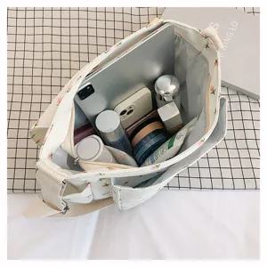 Japanese ins style floral canvas messenger bag, large capacity crossbody bag for student daily use.