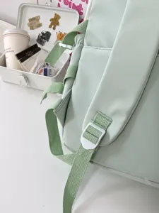 Close-up detail of mint green backpack straps and adjustable buckles, minimalist design style.