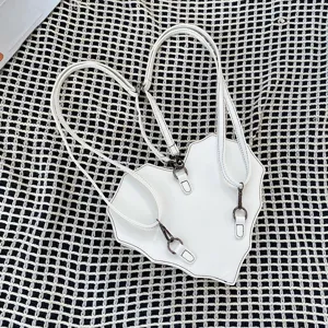 Detail view of the white heart-shaped bat backpack, showing fine stitching and adjustable straps.