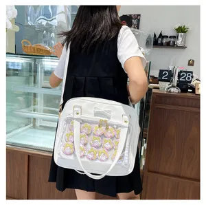 White ita bag with transparent window, cute bow, and anime character badges for women and girls.