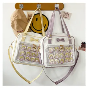 Cute ita bag detail showing clear window pocket filled with anime character badges and sweet bow.