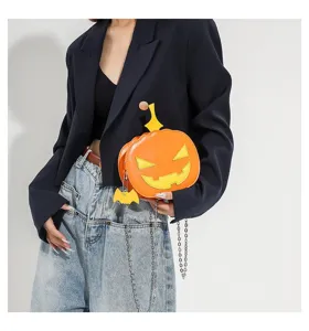 Detailed view of the novelty orange pumpkin shoulder bag featuring chain strap and cute bat charm.