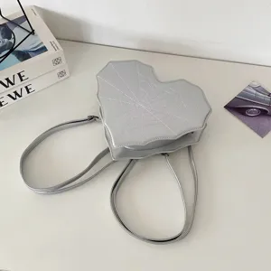 Silver heart spiderweb backpack detail, alternative gothic style cool women crossbody bag