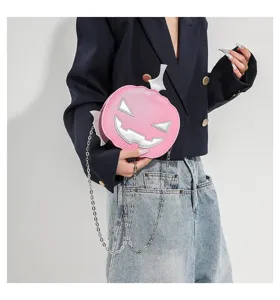 Close-up detail of the pink pumpkin shaped crossbody bag with silver details and metal chain.