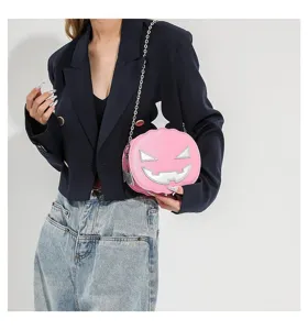 Pink pumpkin shaped crossbody bag detail showcasing silver face and metal chain strap.