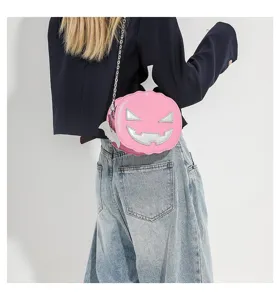 Halloween pink pumpkin shaped crossbody bag detail showcasing silver chain and spooky face decor.