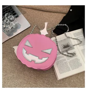 Cute pink Halloween pumpkin shoulder bag with silver chain, stylish cartoon messenger bag.