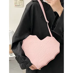 Pink heart-shaped crossbody bag with unique spiderweb stitching, sweet and cool gothic style.