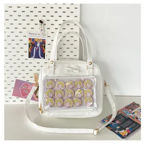White ita bag with transparent window and bow, perfect for anime pins and daily wear.