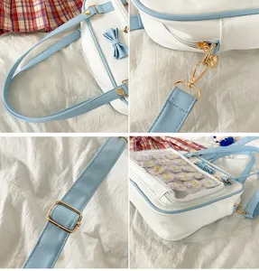 Cute white and blue ita bag with clear window bow and shoulder strap for anime pins display.